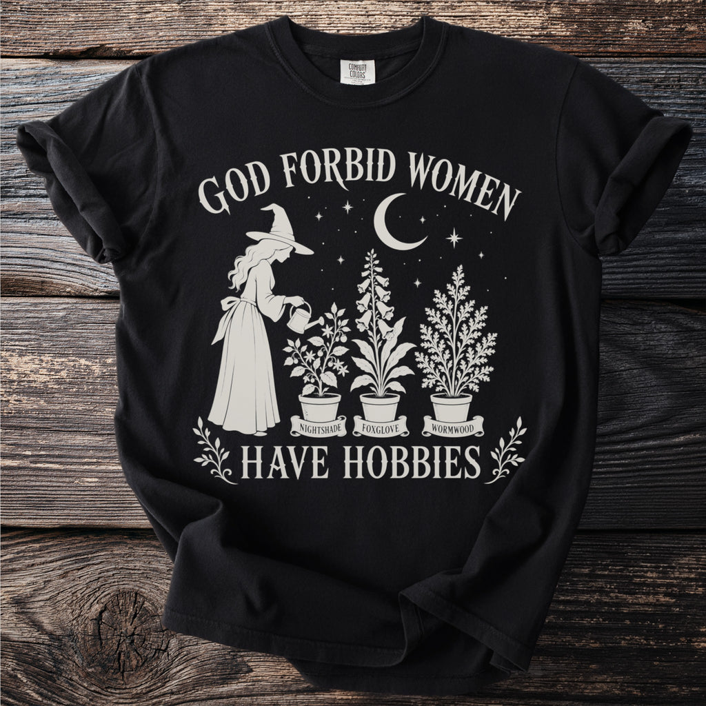 Black t-shirt with witch gardening plants and text "God Forbid Women Have Hobbies".