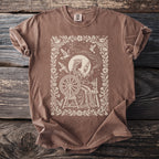 Brown t-shirt with a cream-colored graphic of a queen at a spinning wheel.