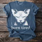 Blue t-shirt with a graphic of a Sphynx cat and the text "born tired".
