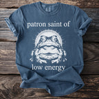 Blue t-shirt graphic with a toad and text "patron saint of low energy".