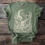 Green t-shirt with skull, raven, crescent moon, mushrooms, and candles graphic.