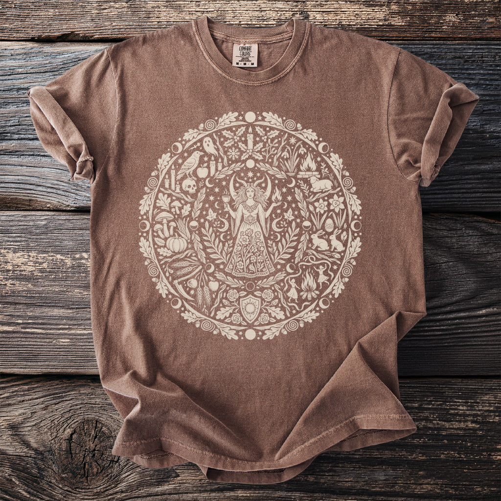 Brown t-shirt with a circular pagan-themed design featuring a woman and nature elements.
