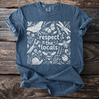 Blue t-shirt with white illustration of insects, flowers, and the text "respect the locals."