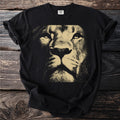 Black t-shirt with a close-up graphic of a lion's face in gold.
