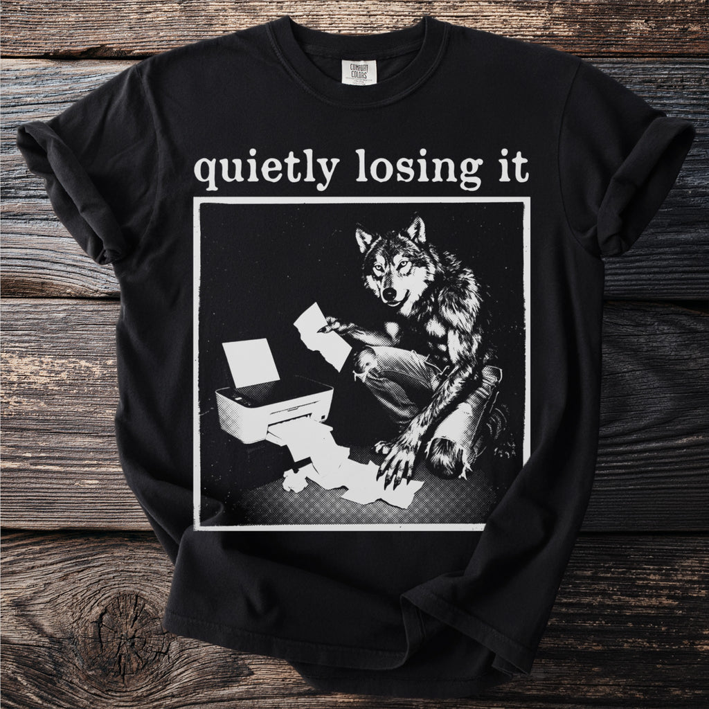 Black t-shirt with text "quietly losing it" above a wolf-like creature by a printer.