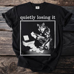Black t-shirt with text "quietly losing it" above a wolf-like creature by a printer.