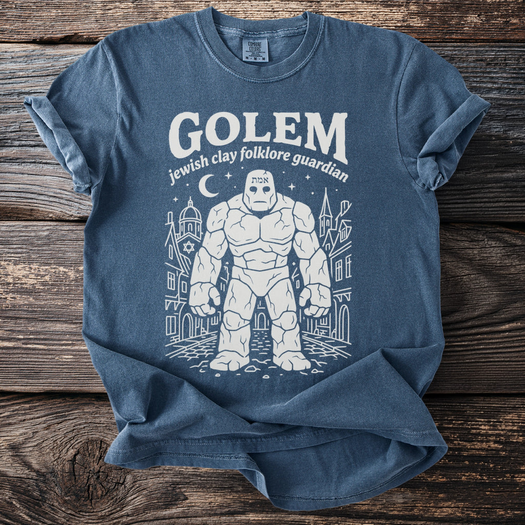 Blue t-shirt with a white line drawing of a golem and city buildings.