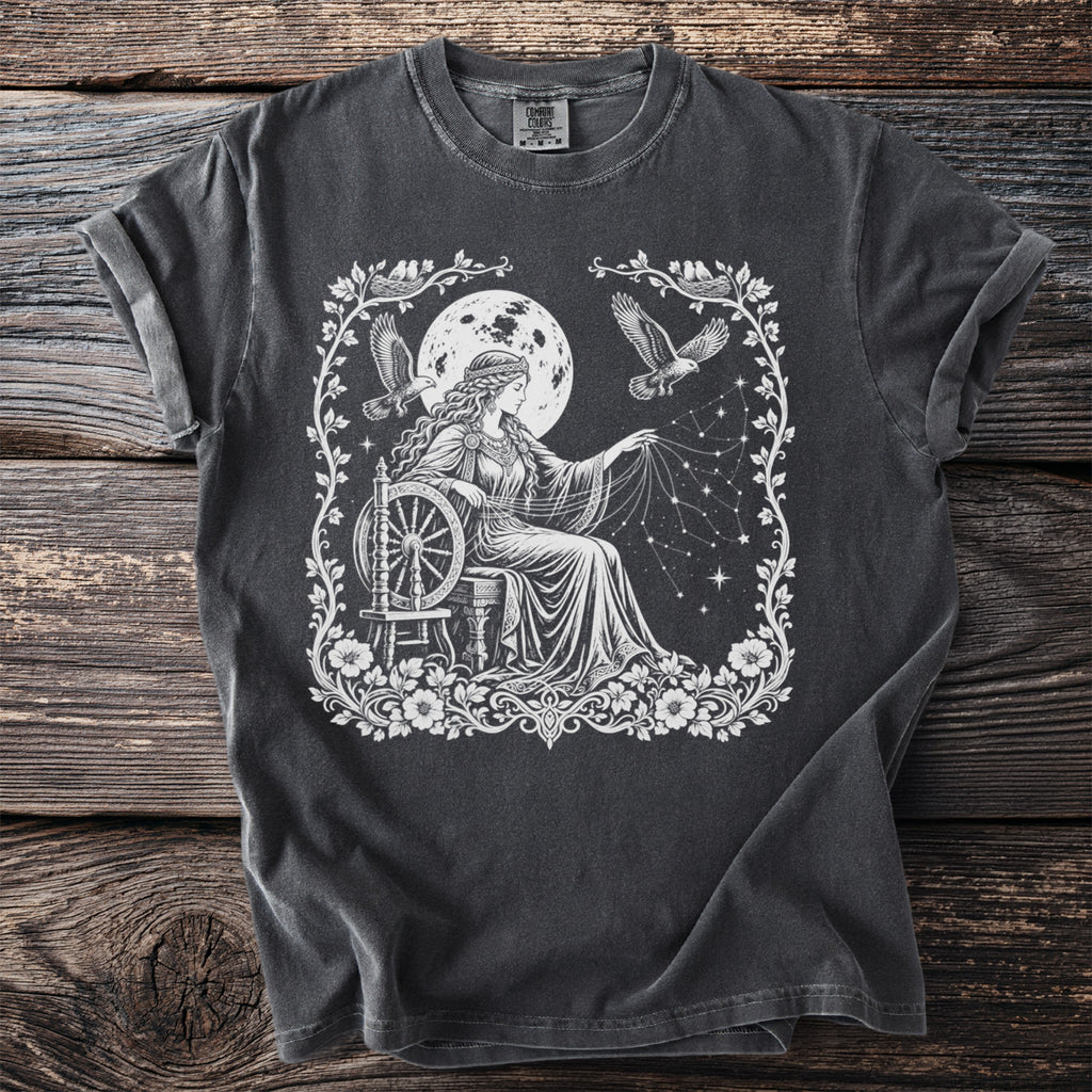 T-shirt with white graphic of woman spinning stars under moon with birds.