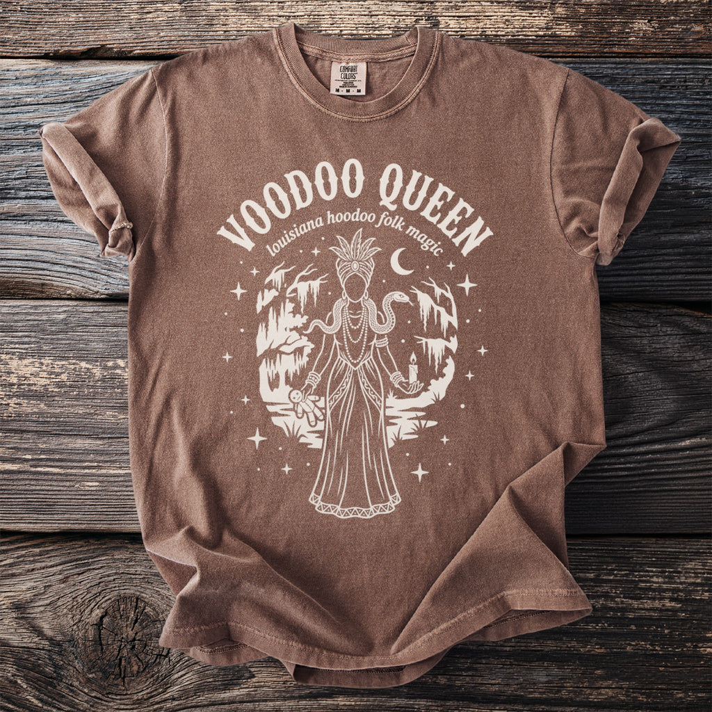 Brown t-shirt with Voodoo Queen graphic featuring a draped figure, snake, candle, and voodoo doll.