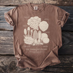 Brown t-shirt featuring a cream line drawing of various fungi labeled "The Forager's Fungi".