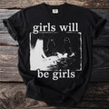 Black t-shirt with "girls will be girls" text and a gritty graphic of figures.