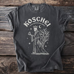 Dark gray t-shirt graphic of Koschei, a skeleton king holding a mirror near a castle and tree.