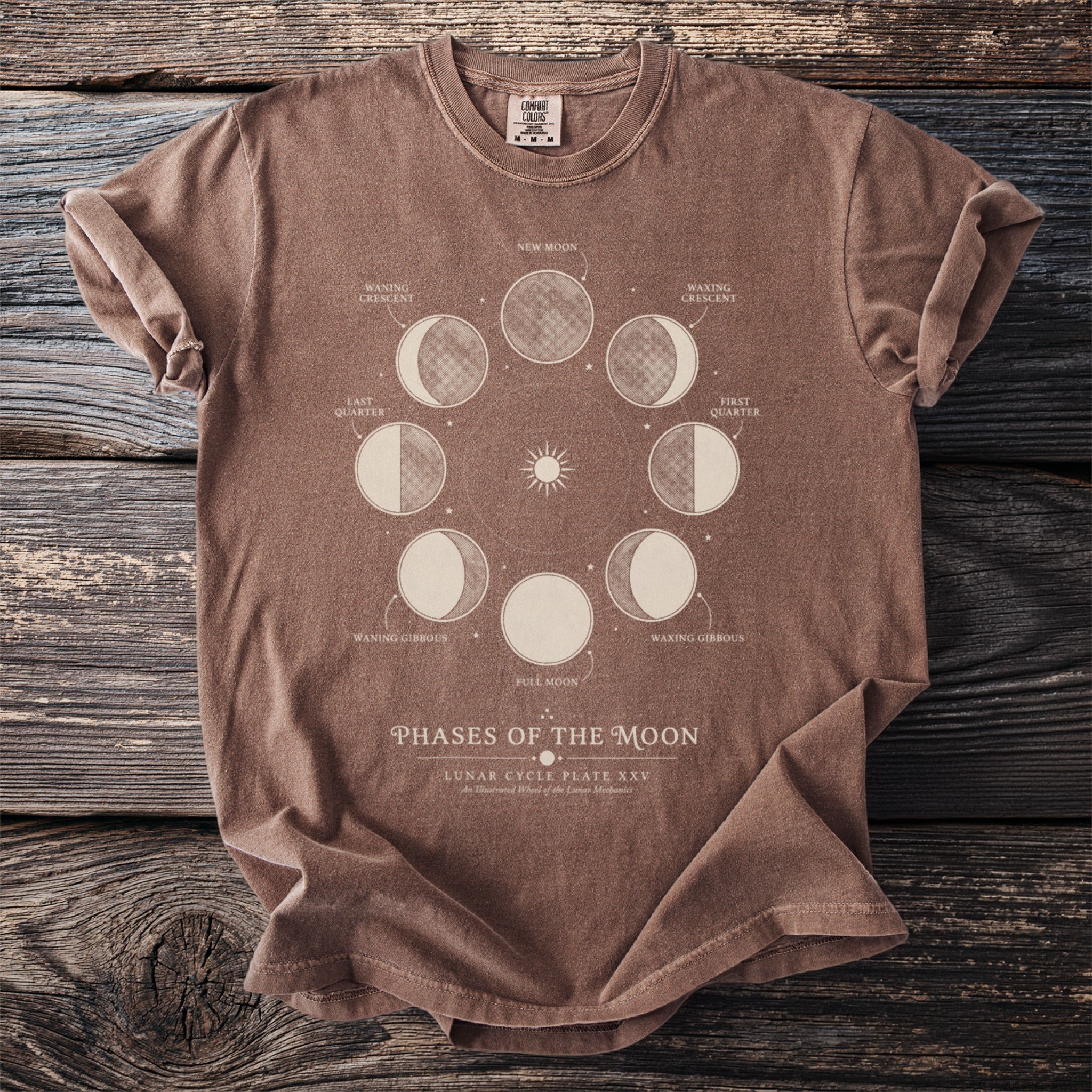 Brown t-shirt with "Phases of the Moon" graphic showing lunar cycle stages.