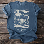 Blue t-shirt with vintage-style illustrations of deep-sea creatures and text "The Abyss."