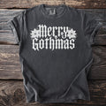 Dark gray t-shirt with white "Merry Gothmas" text and skull designs.