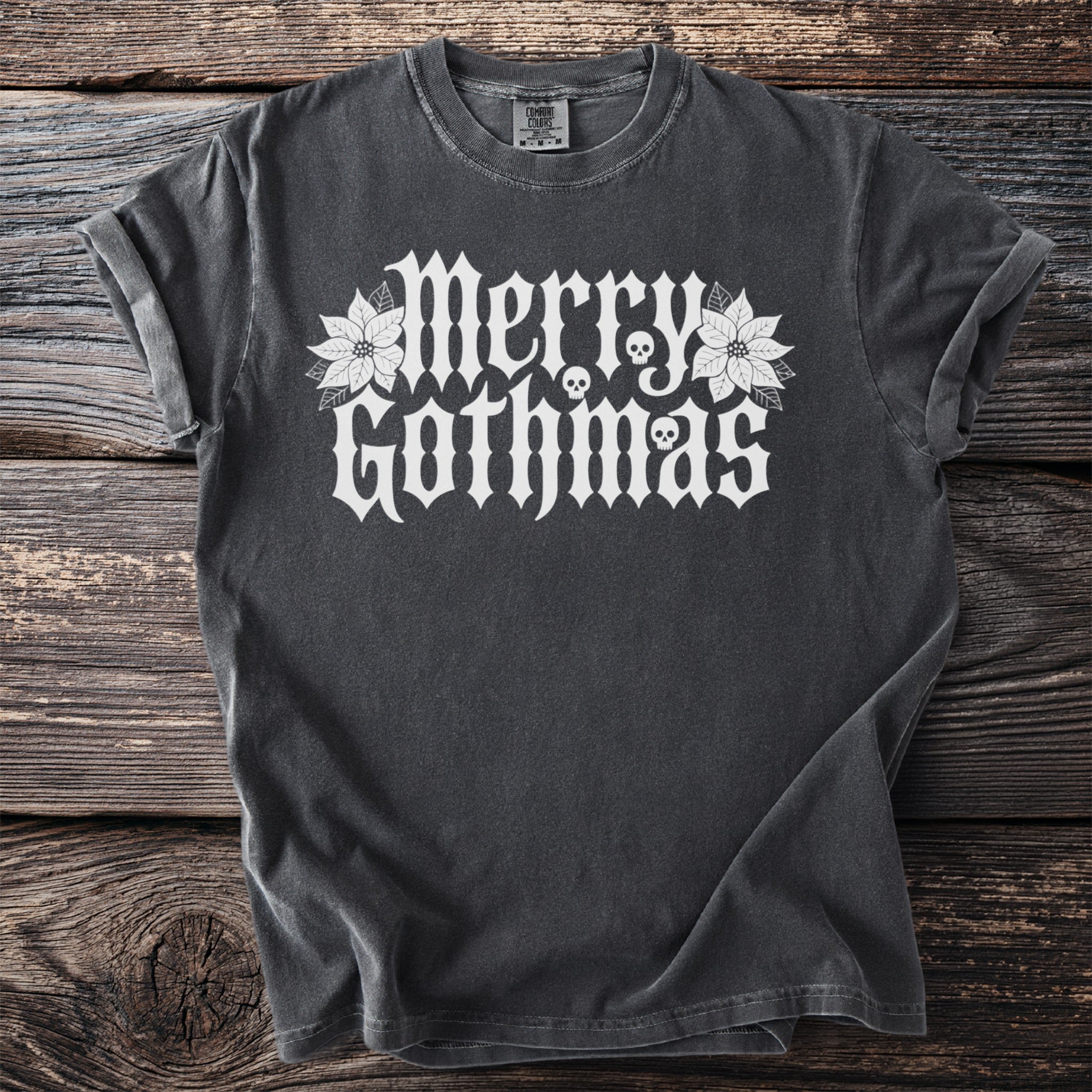 Dark gray t-shirt with white "Merry Gothmas" text and skull designs.