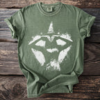 Green t-shirt with a white witch silhouette and sparkling stars graphic.