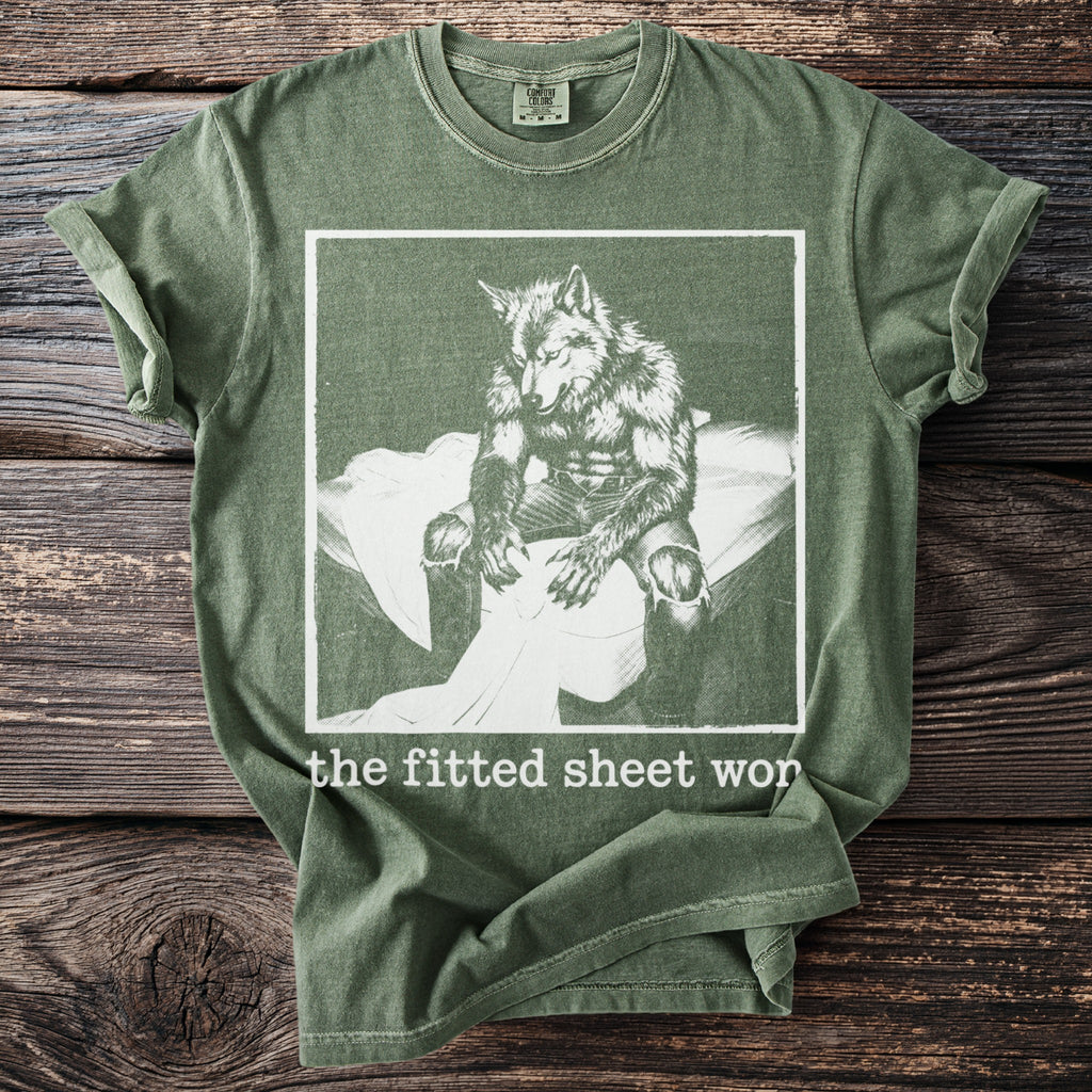 Green Comfort Colors t-shirt with werewolf graphic and "the fitted sheet wor" text.