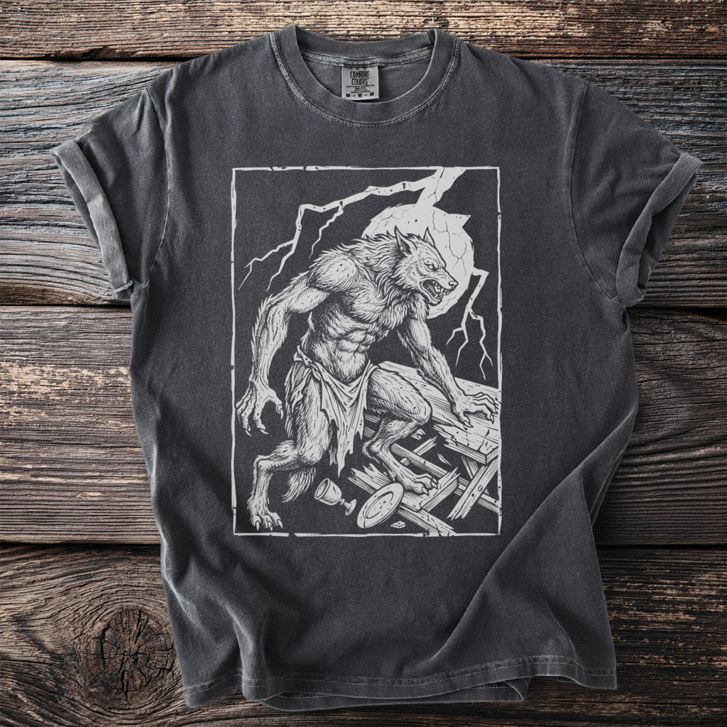 Werewolf illustration on dark gray t-shirt with tattered cloth and wooden debris.