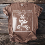 Brown t-shirt with wolf holding a baby and text "nocturnal by necessity."