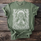Green t-shirt with a white werewolf graphic among trees and a moon.