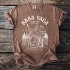 Brown t-shirt with Baba Yaga folklore illustration and text.