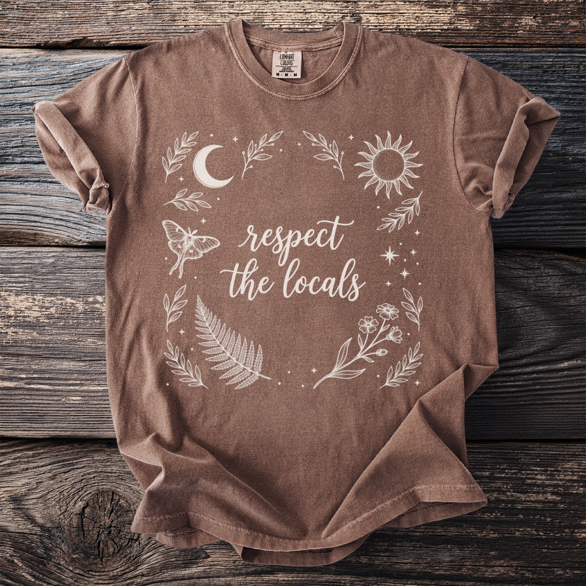 Brown t-shirt with white "respect the locals" text and celestial graphic.
