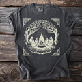 T-shirt with a graphic of figures sitting around a campfire under trees.