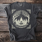 T-shirt with a graphic of figures sitting around a campfire under trees.