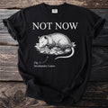 Black t-shirt with opossum illustration, text "NOT NOW" and "Fig. 1: Involuntary Leave."