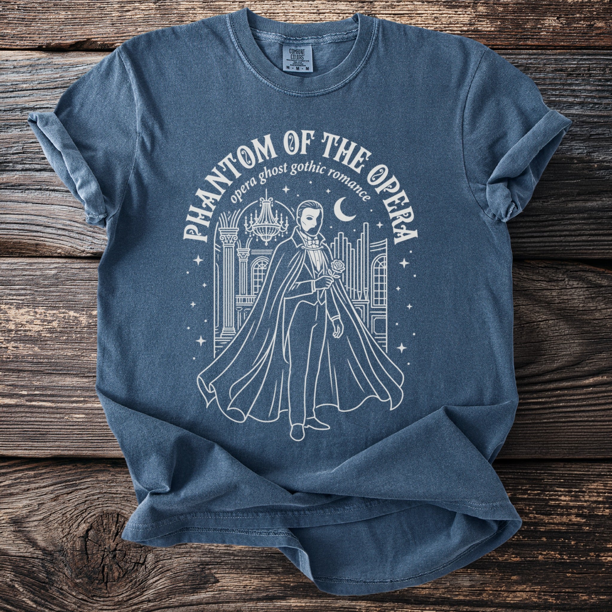 Phantom of the Opera graphic on a blue t-shirt with text.