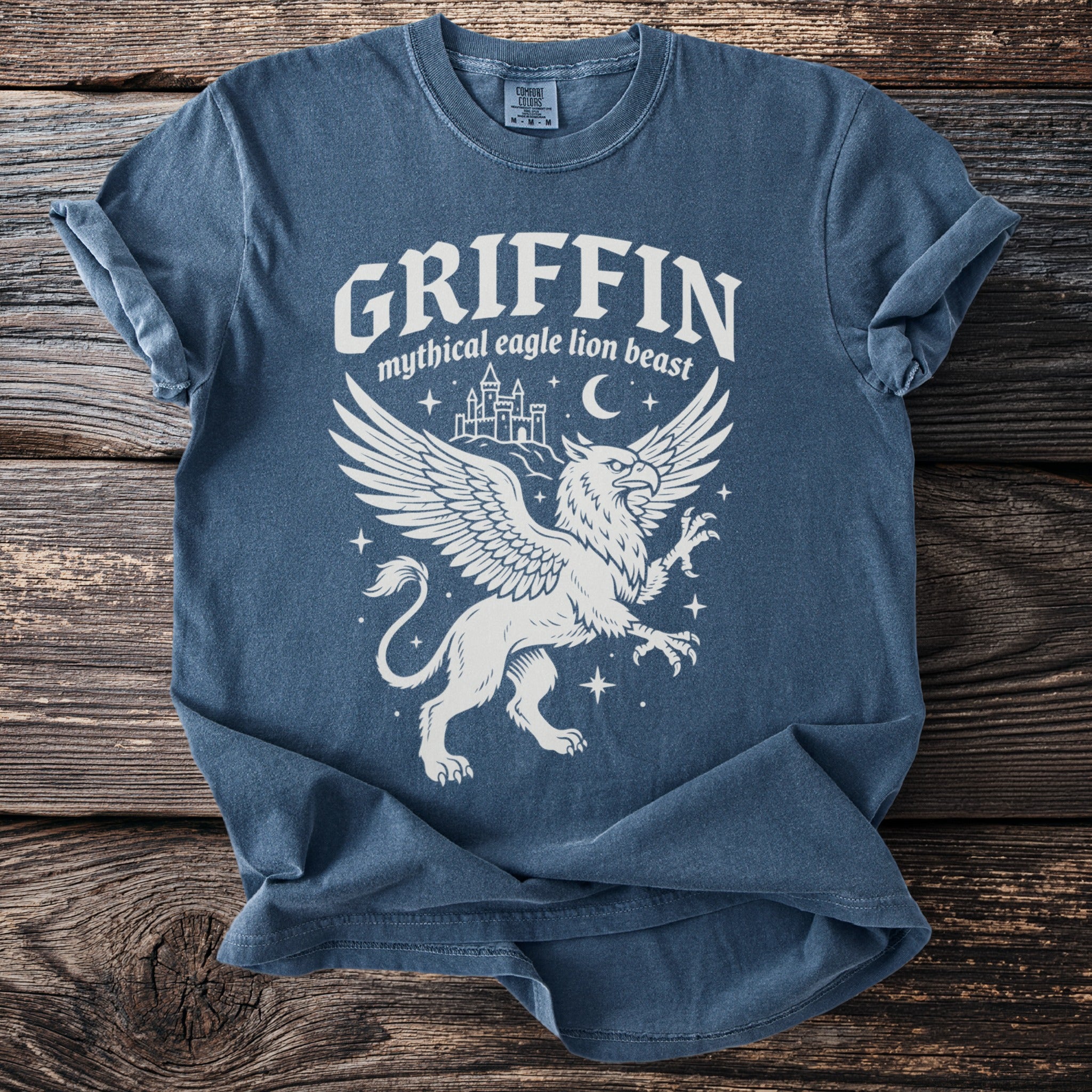 Blue t-shirt with a white griffin graphic and text Griffin Mythical Eagle Lion Beast.