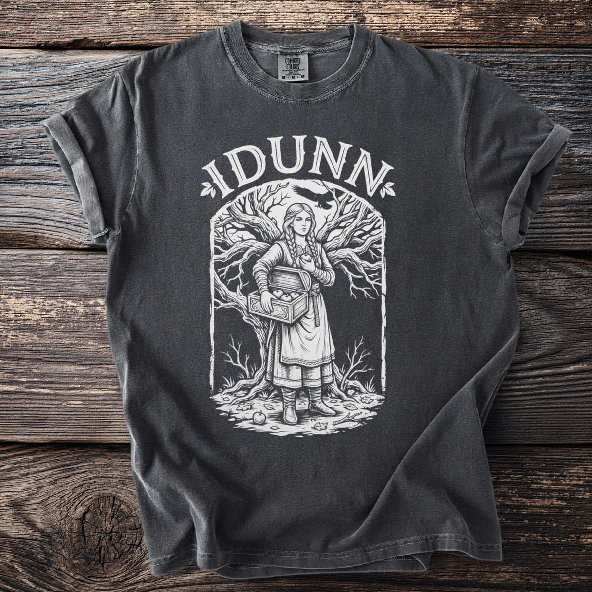 "Idunn" text above illustration of woman with apples and raven on t-shirt.
