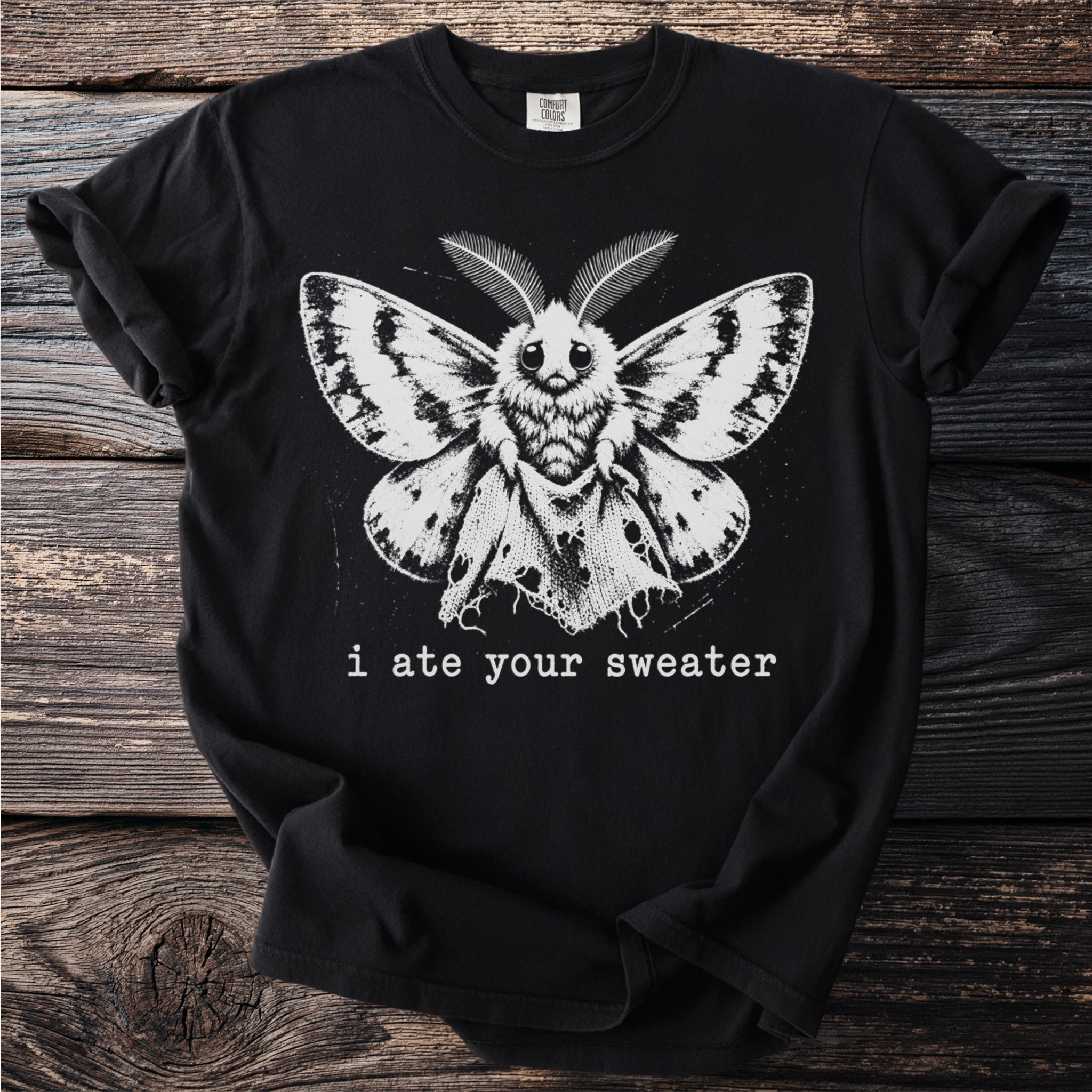 Black t-shirt with a moth graphic and the text "i ate your sweater".