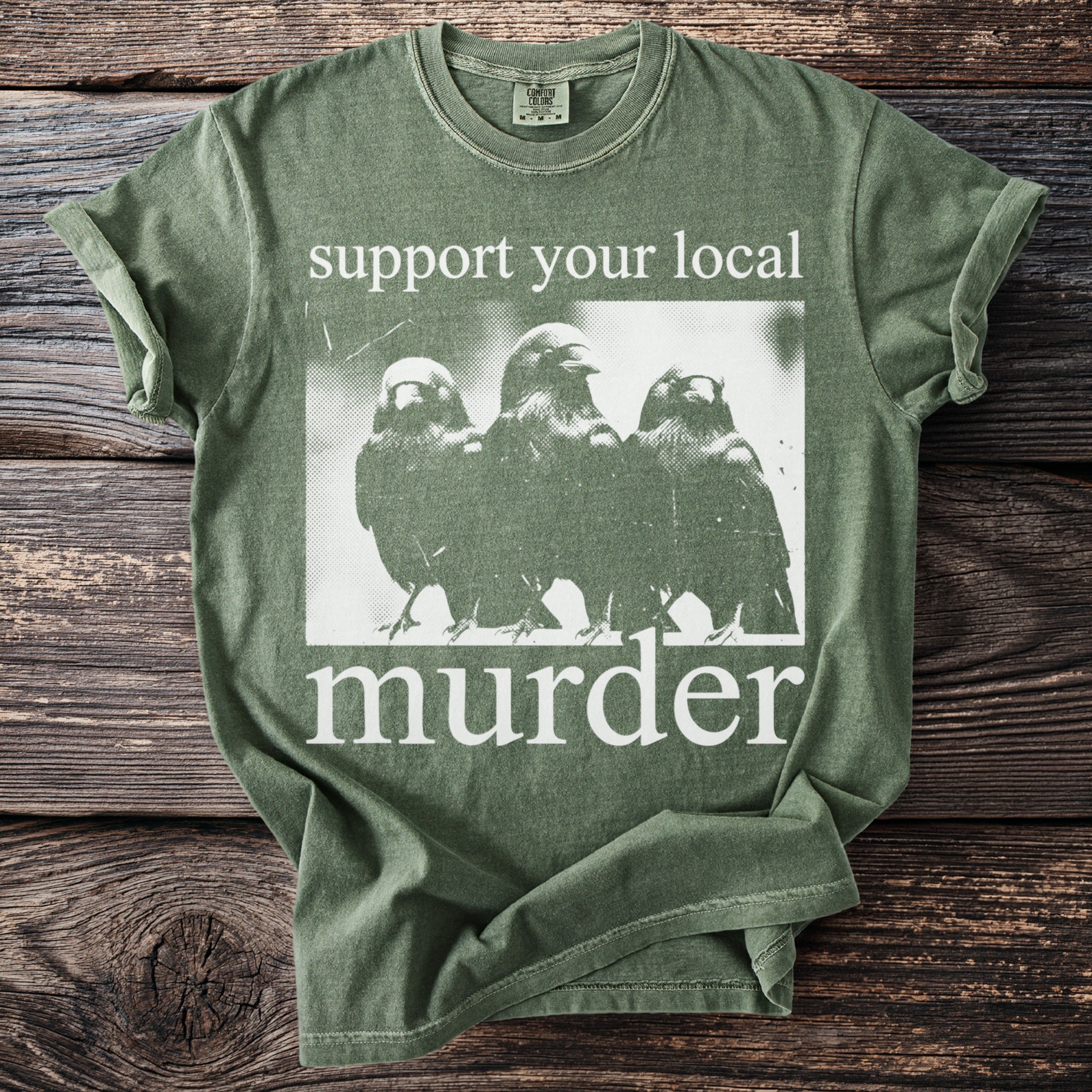 Green t-shirt with "support your local murder" text and three birds graphic.