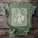 Green t-shirt with a winged warrior, shield, spear, and two ravens illustration.