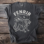 Dark grey t-shirt with white graphic of Fenrir, Norse mythology giant wolf, chained with mountains and moon.