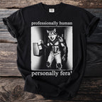 Black t-shirt with a werewolf clocking in, text reads "professionally human, personally feral".