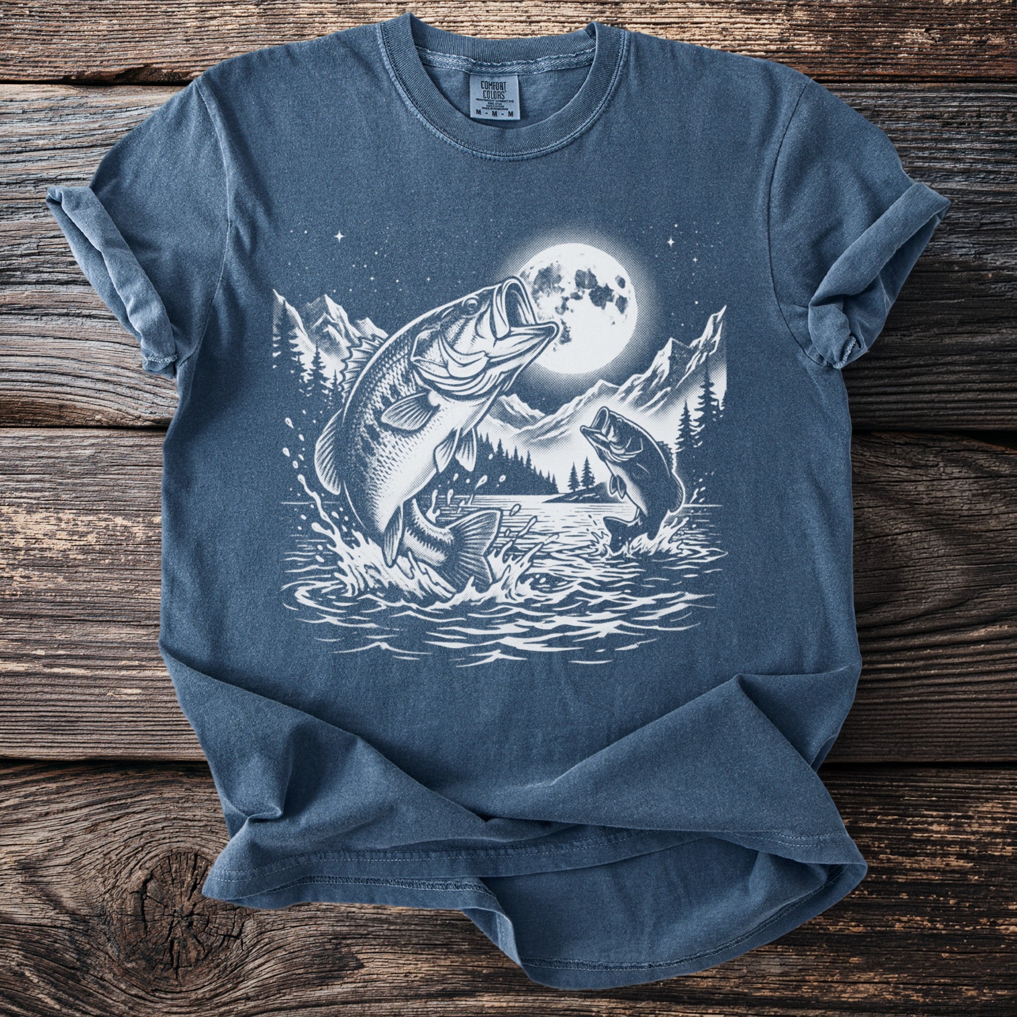 Blue t-shirt graphic of bass jumping out of water under a full moon.