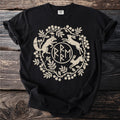 Black t-shirt with a tan circular emblem of a fox, rabbits, and foliage.