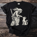 Baba Yaga in her mortar, broom beside her, boops a cat on the nose.