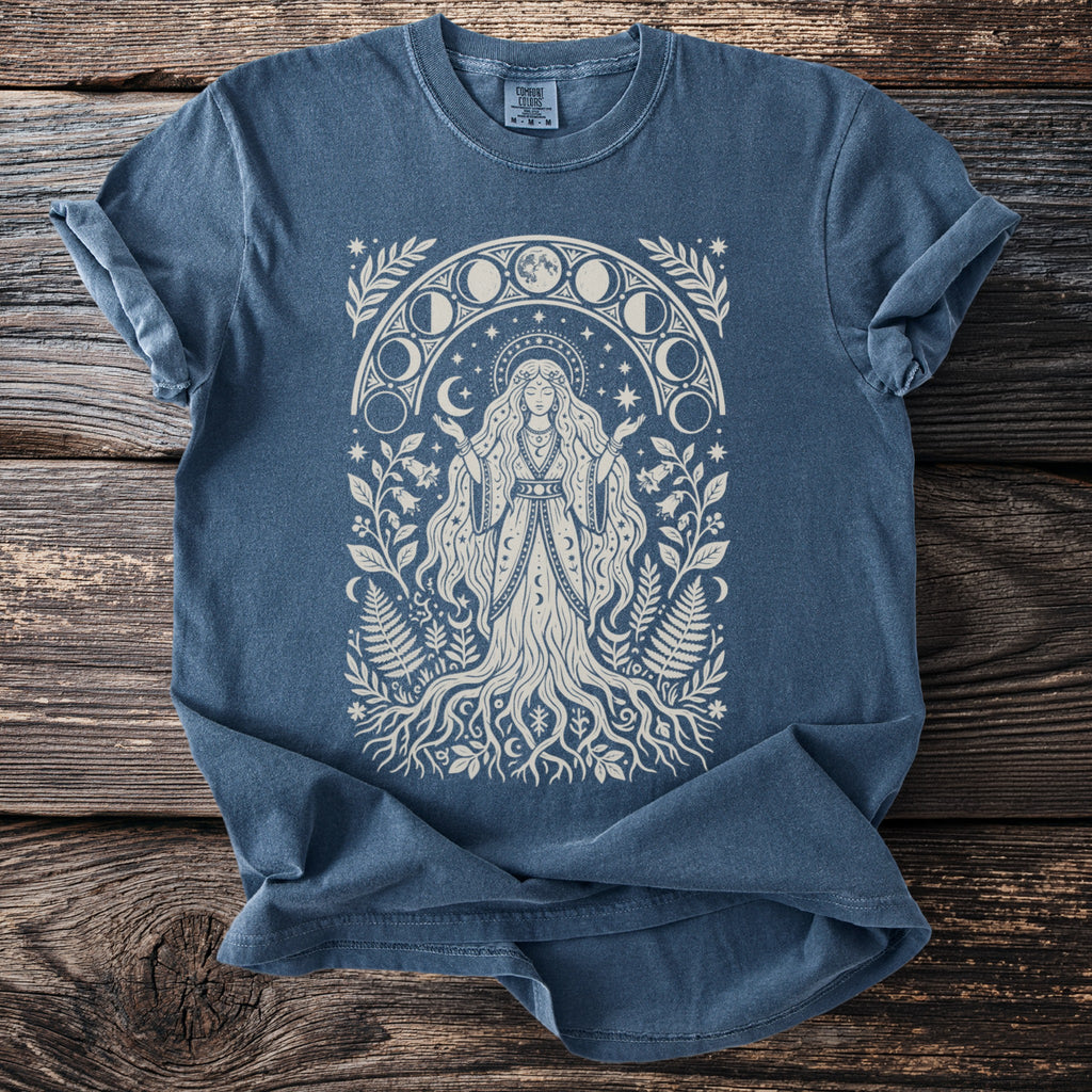 Blue t-shirt with a cream-colored graphic of a woman surrounded by moon phases and foliage.
