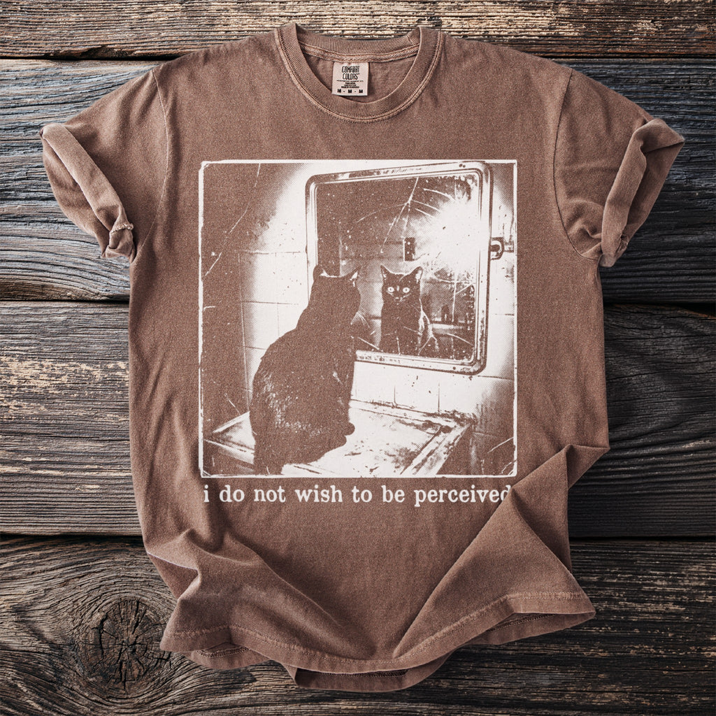 Brown t-shirt with a dark cat looking in a cracked mirror with text "i do not wish to be perceived".