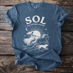 Blue t-shirt with white "SOL Norse mythology sun goddess" graphic and celestial imagery.