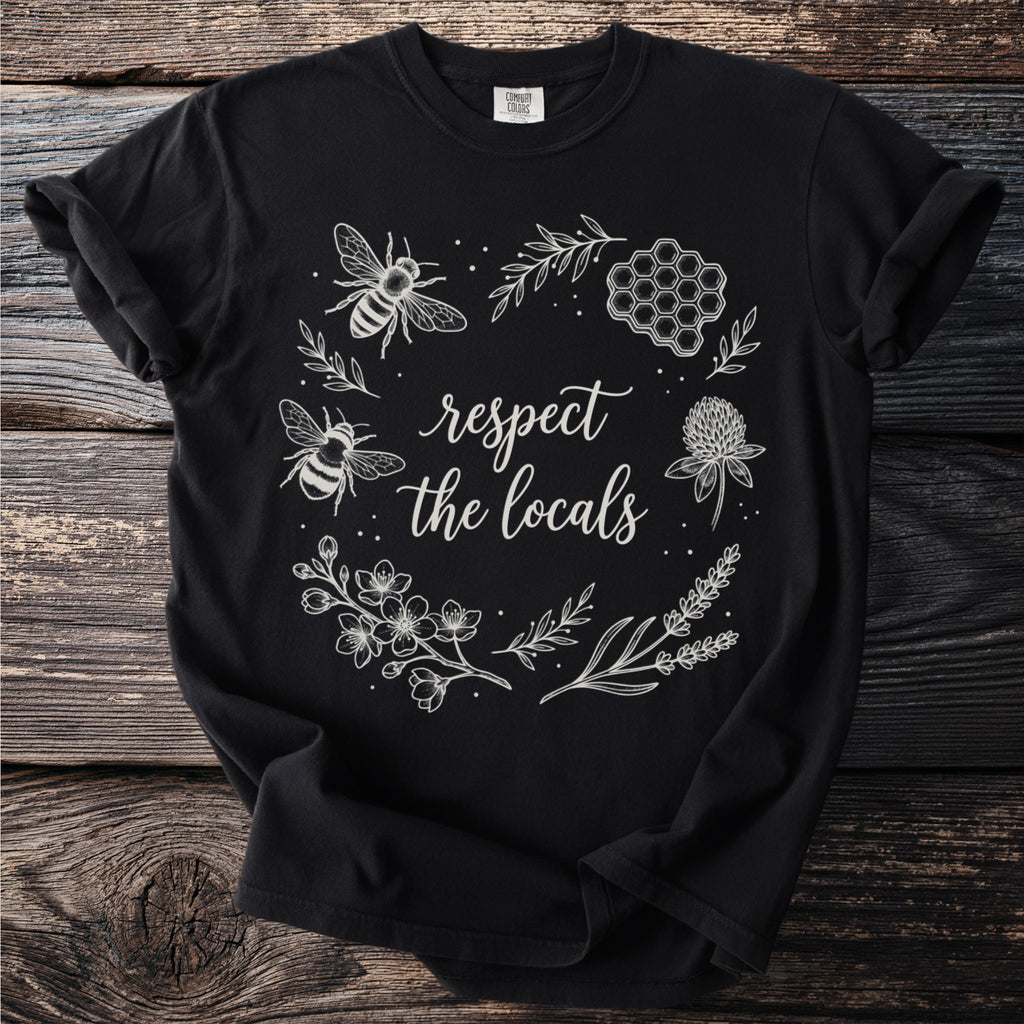 Black t-shirt with white floral and bee graphic that reads "respect the locals."