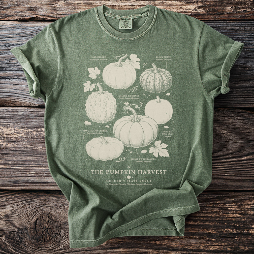 Green t-shirt with white illustration of pumpkins labeled "The Pumpkin Harvest".