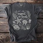 Dark grey t-shirt with white line art: "respect the locals" and marine life.