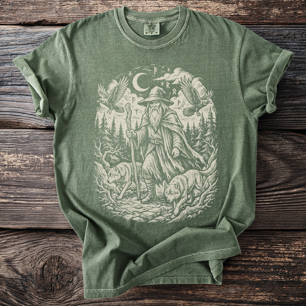 Green t-shirt with a cream graphic of a wizard, two wolves, two ravens, and runes.