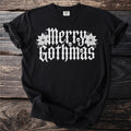Black t-shirt with white "Merry Gothmas" text, skulls, and poinsettias.