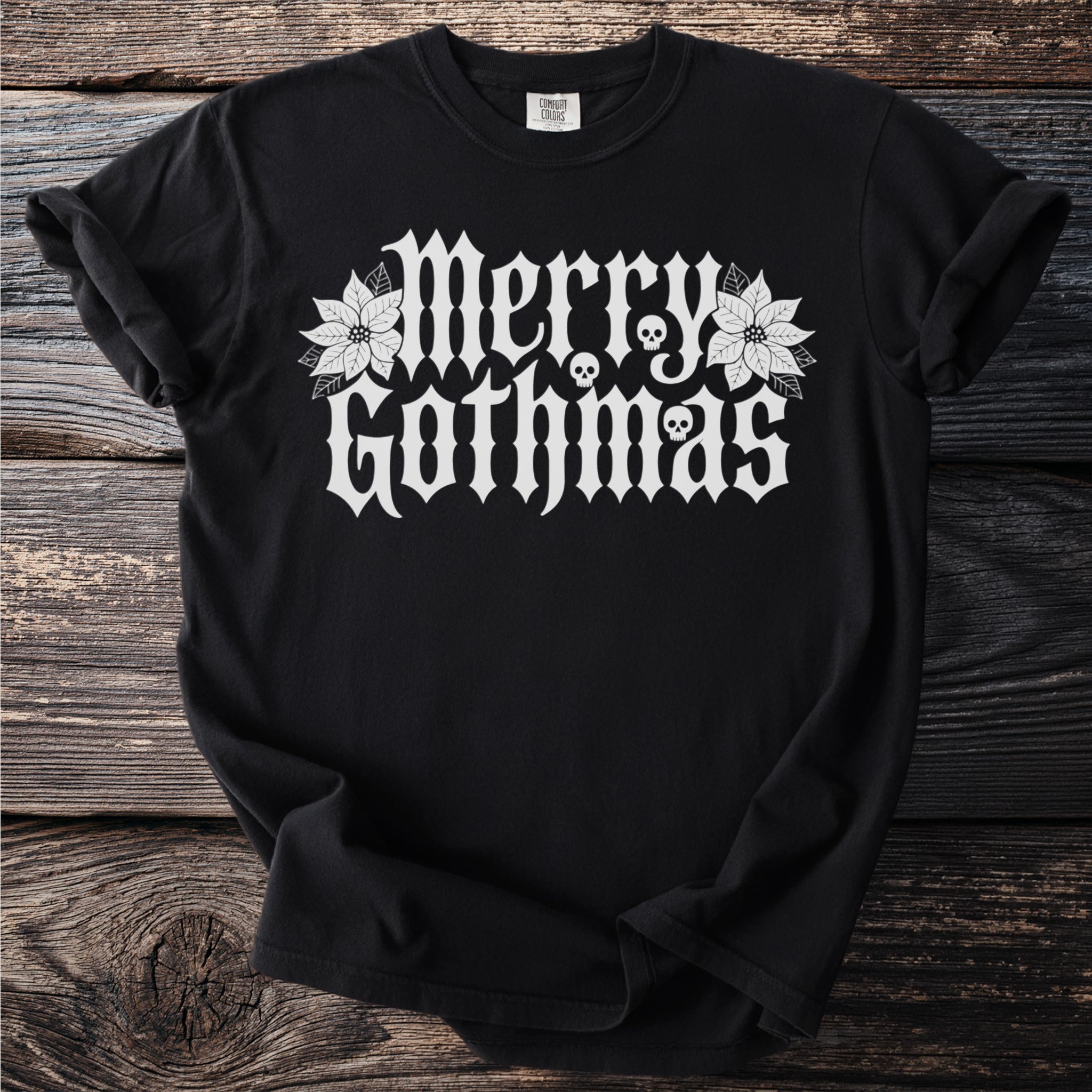 Black t-shirt with white "Merry Gothmas" text, skulls, and poinsettias.